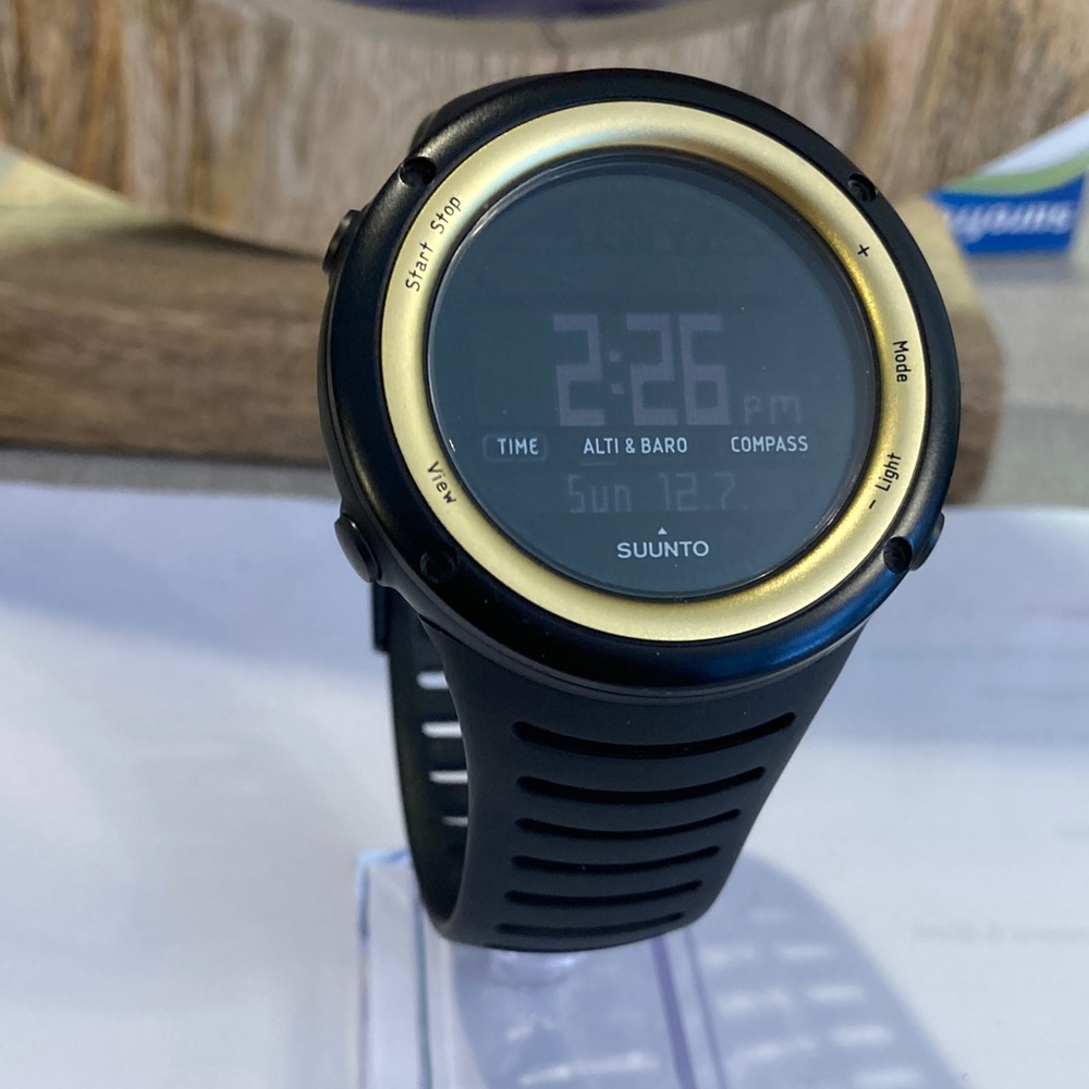 Suunto Core watch, black case and strap with gold tone bezel, working battery